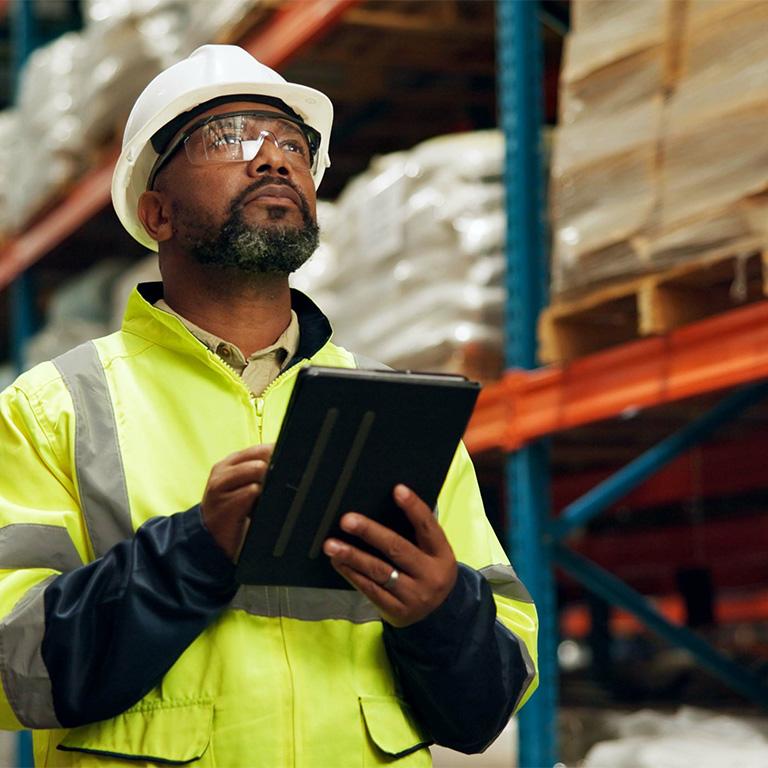 man in a warehouse with a tablet